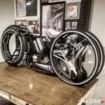 A sleek, futuristic blue and black tron 2022 jrat customs bike with glowing lines.